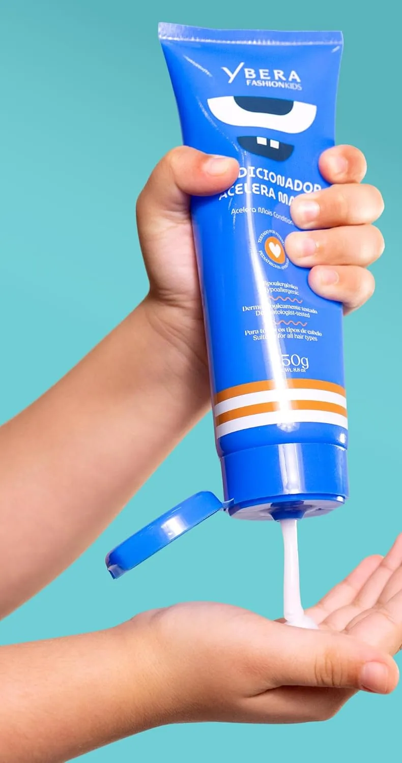 A child's hand squeezing the blue kids' conditioner tube into an open palm